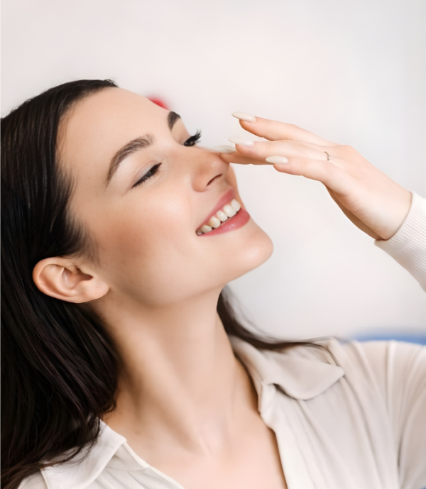 Woman smiling after rhinoplasty nose surgery consultation at MicroCare ENT Hospital Hyderabad